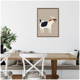Framed canvas illustration of a white goat with black and brown patches, displayed on a beige background above a wooden dining table and white chairs.