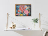 Wall art featuring vibrant coral and underwater plants in shades of coral pink, yellow, and blue on a dark background above a white hanging shelf with gold supports.