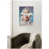 Framed canvas print showing a pale woman with blonde hair and red lips, a large white moth covering her eyes, celestial symbols and starry background behind her.