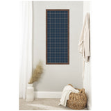 Tall rectangular pinboard with a navy blue and white plaid fabric inside a dark wood frame, mounted on a light gray wall above a woven basket and decorative vase.