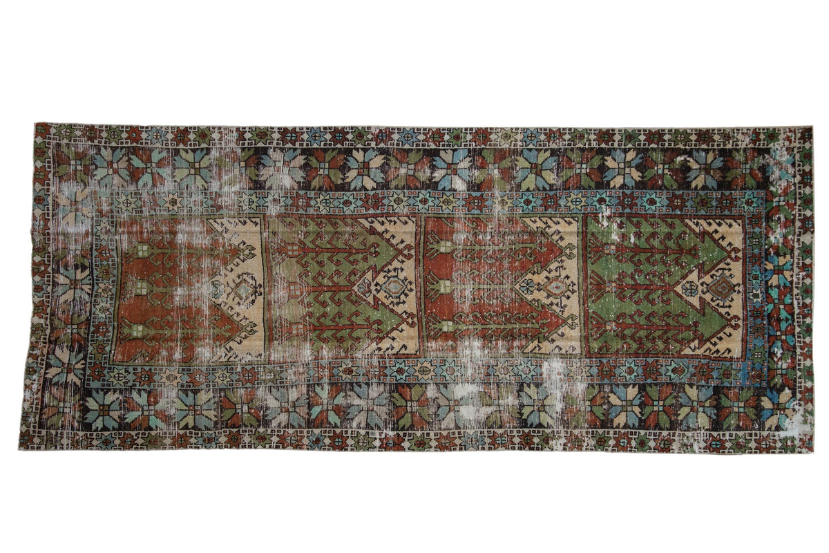 4.5x10.5 Vintage Distressed Oushak Rug Runner showing multi-panel prayer mehrab design with starburst floral border in muted sage green, rust, ivory, and powder blue tones.