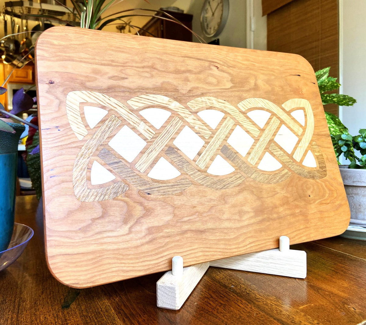 Cherry wood charcuterie board with white oak and maple Celtic knot inlay by Fitzgerald Custom Woodcraft