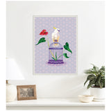 White cockatoo perched on a violet cage surrounded by green anthurium leaves and one red anthurium flower, against a soft purple patterned background, framed and displayed on a white wall.
