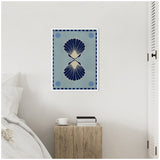 Framed canvas featuring two symmetrical dark blue seashells on a muted blue background with sunburst motifs in corners, hanging above a rustic wooden nightstand.