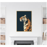 Framed wall art featuring a stylized side profile of a tiger with orange, cream, and black stripes against a solid navy blue background, centered above a white fireplace.