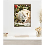 Close-up of a framed canvas showing a sleeping polar bear resting beneath a decorated Christmas tree with red ornaments and green branches.