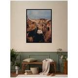 Framed wall art print of a close-up Highland cow with long brown hair and large curved horns against a cloudy blue sky, hung above a green-paneled wall and wooden bench.