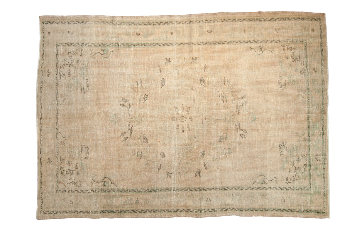 5.5x8 Vintage Distressed Oushak Carpet featuring scalloped center medallion and floral patterns in muted tones