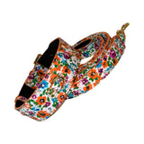 Italian leather dog collar and leash set decorated with a vibrant floral pattern featuring orange, purple, blue, and green flowers on a white background with gold-tone hardware.