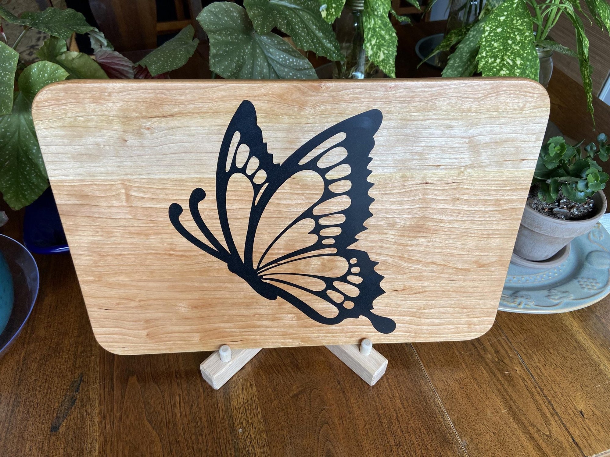 Cherry wood charcuterie board with butterfly-shaped resin inlay