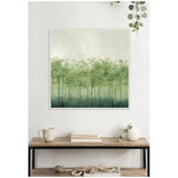 Framed wall art of abstract green trees with tall dark trunks and lush, varying green foliage fading into a light background, hanging above a wooden console with decor.
