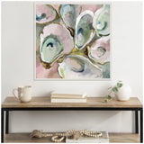 Square framed canvas showing an abstract composition of oyster shells in pastel shades of blue, green, pink, and white with gold accents on a soft pink background.