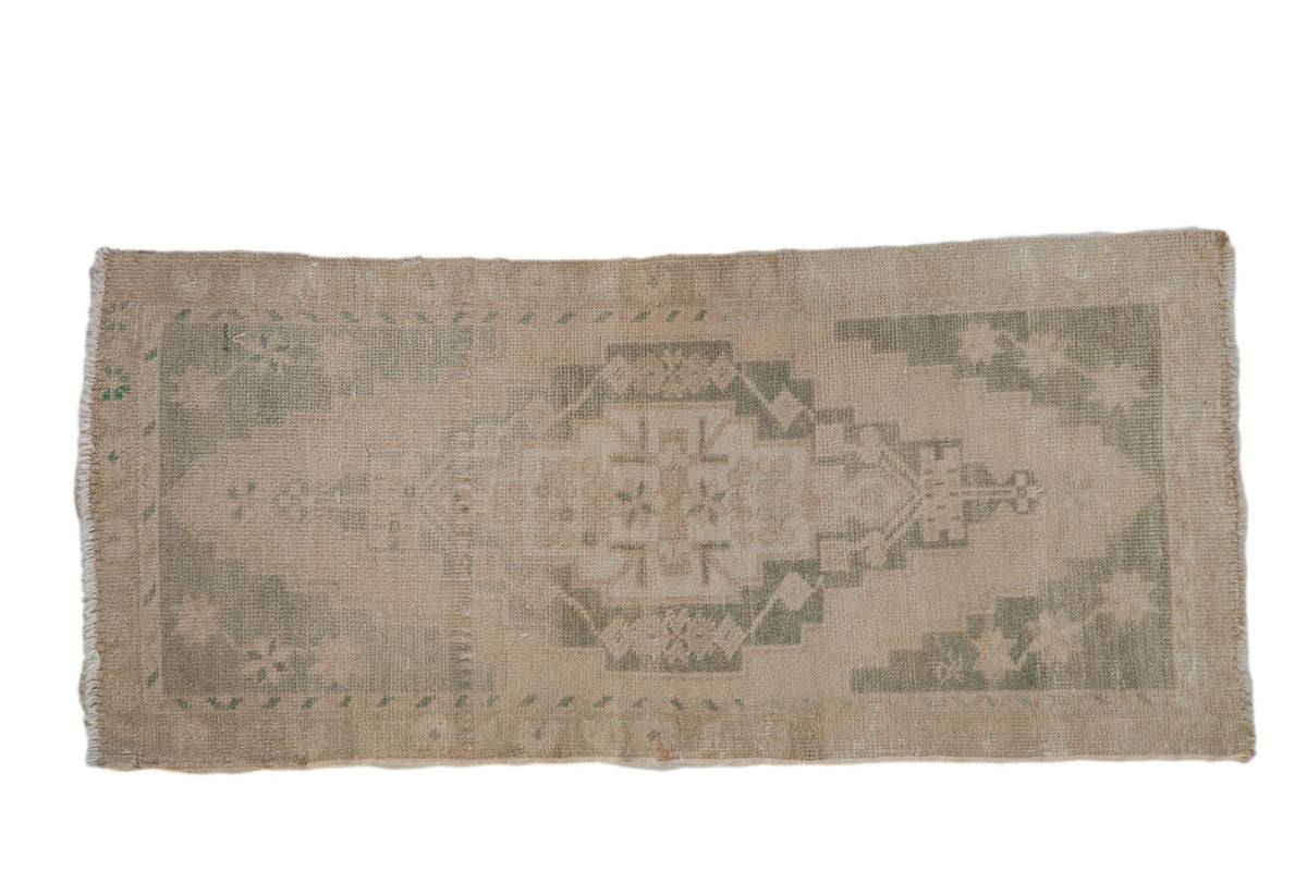 Vintage distressed Oushak rug with concentric medallions and starburst floral motifs in cream, seafoam green, beige, and sand tones