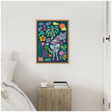 Brightly colored canvas print of a stylized zebra with pink and blue stripes among lush tropical plants and flowers, framed in light wood and hung on a white wall.