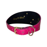 Wide fuchsia pink snake-patterned collar with gold buckle and D-ring, featuring a black interior lining and three small gold rivets.