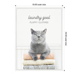 Gray cat with closed eyes perched on a stack of folded beige, cream, and gray towels framed with caption 'laundry goal FLUFFY CLOTHES' above.