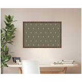 Wall-mounted rectangular dark green pinboard with evenly spaced small white botanical prints above a wooden desk and beside a leafy plant.