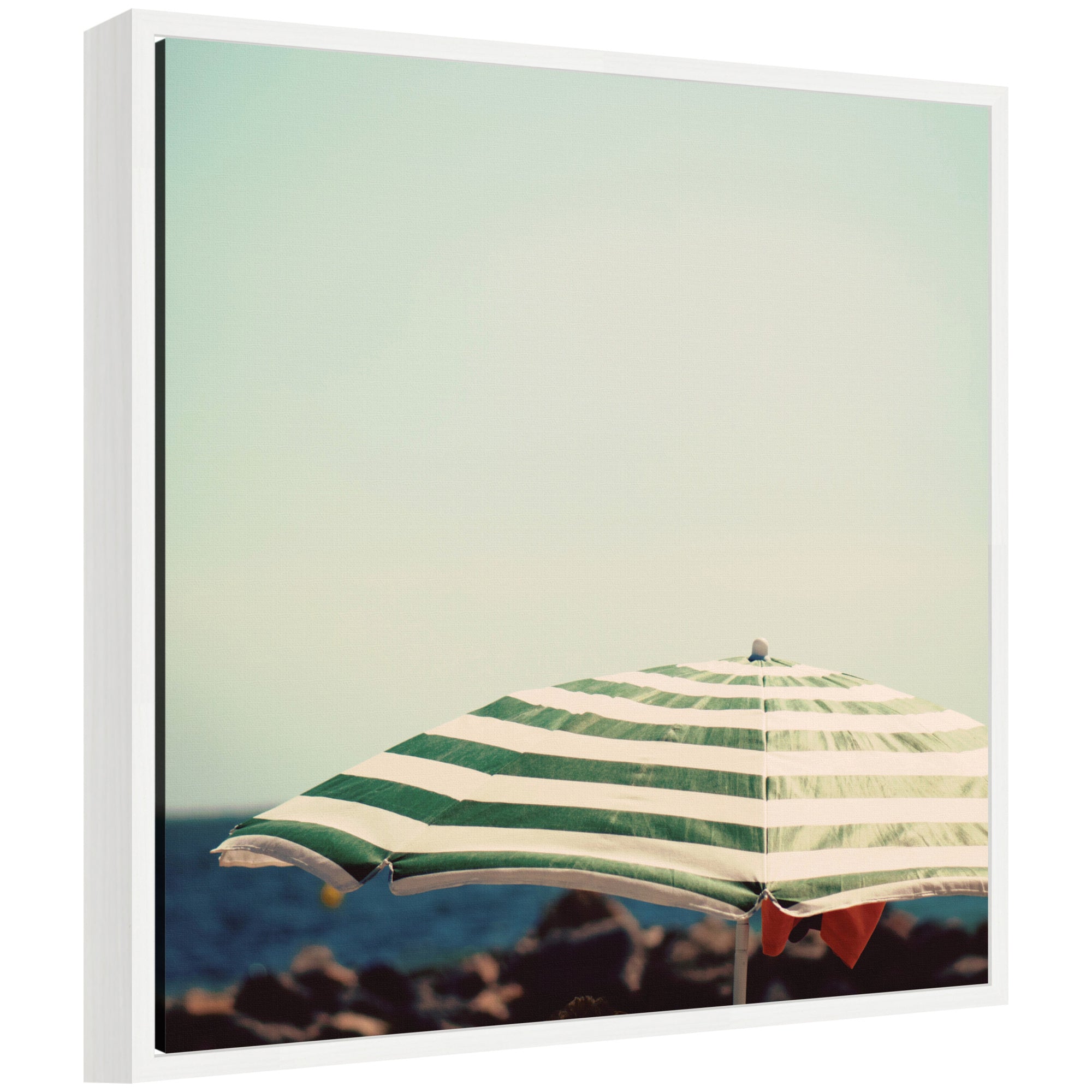 Framed canvas wall art titled 'Under the Umbrella' by Laura Evans showing a coastal scene in a white frame