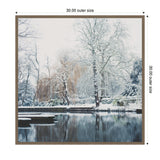 Square framed canvas showing snow-covered trees and punts along the calm River Cam with muted winter colors and bare branches reflecting on the water surface.