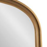 Close-up of an arch-shaped wall mirror with a smooth, light wood frame featuring layered curved ridges around the reflective glass surface.