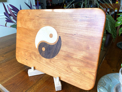 Cherry wood charcuterie board with Yin Yang inlay of Maple and Peruvian Walnut