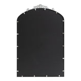 Rectangular mirror with an arched top and a decorative silver crest at the top center, shown from the back with metal clips around the edge.