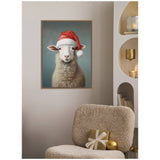Framed canvas of a fluffy sheep wearing a red Santa hat against a blue-gray background, displayed above a beige textured chair with gold and white holiday decor.
