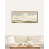 Framed landscape painting above beige sofa featuring soft clouds over muted green and brown meadows, complemented by a white pillow and a wooden coffee table with a white vase and books.