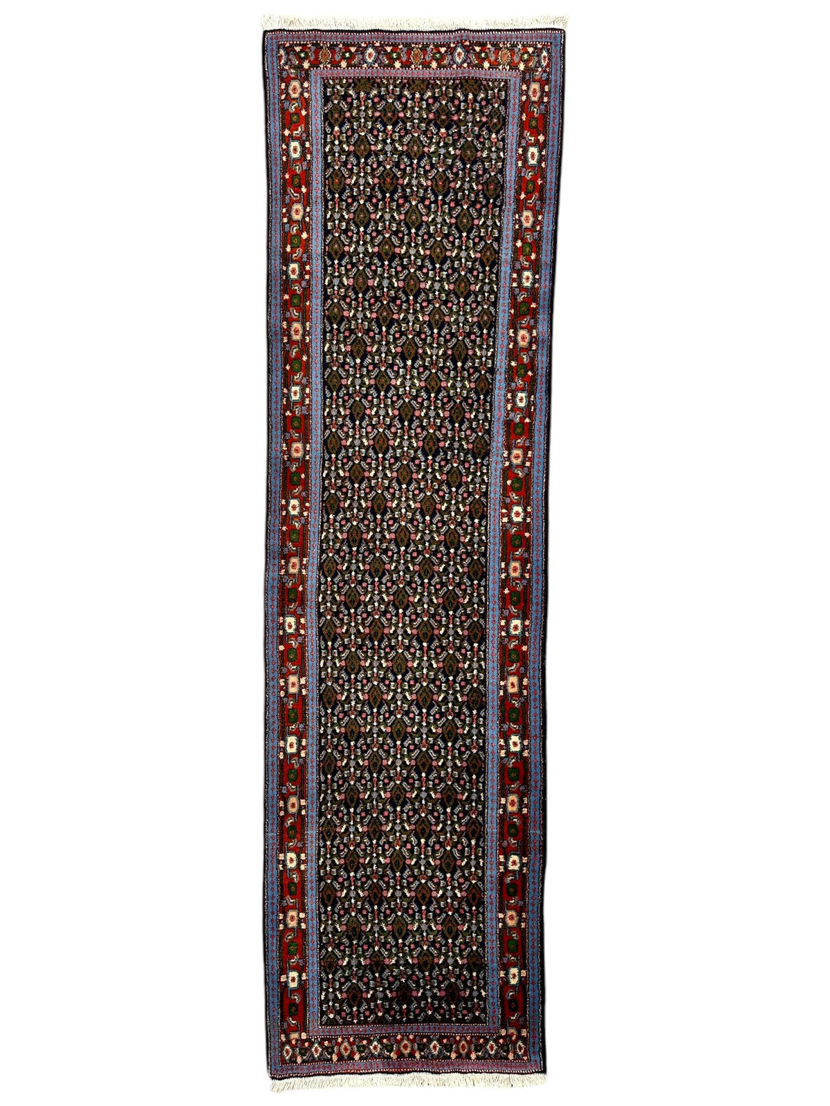 Long narrow Persian Senneh runner rug with a dark, densely patterned central field framed by red and blue borders featuring floral motifs.