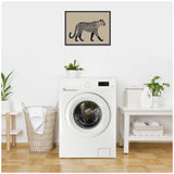 Framed linocut-style leopard print with beige background hanging above white front-load washing machine in a bright, minimalist laundry room.