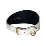 White textured leather collar with a gold buckle and two gold rings, featuring a black interior with gold script text.
