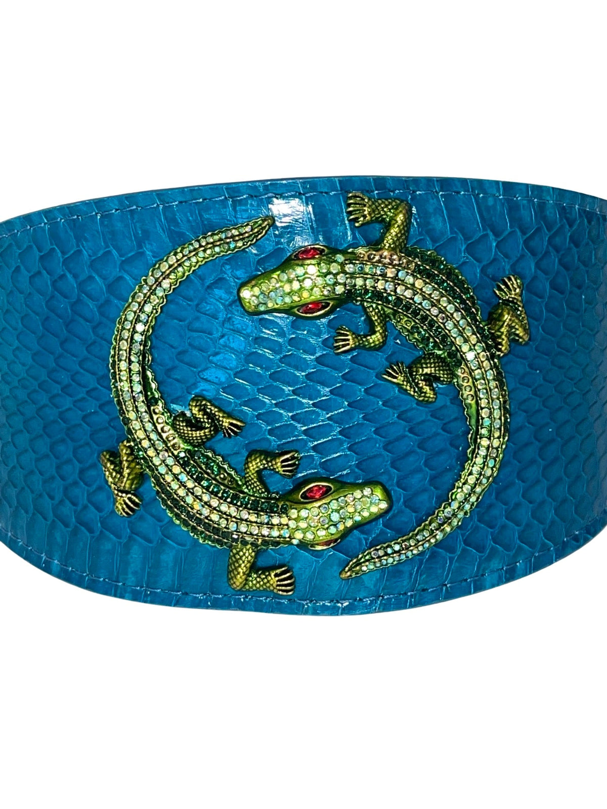 Dark turquoise band with textured snake skin pattern featuring two green rhinestone alligators with red eyes positioned in a circular arrangement