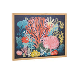 Colorful underwater coral reef print featuring various coral shapes in bright coral pink, blue, yellow, and green on a dark navy background with a light wood frame.