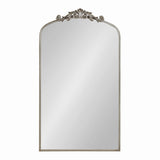 Tall rectangular mirror with rounded top corners and a silver ornate scrollwork decoration centered on the top arched frame edge.