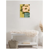Framed canvas painting of pale pink blossoms with green leaves in a striped green vase, hanging above a white bench draped with a fluffy cream throw in a minimalist room.