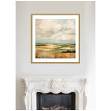 Framed abstract landscape painting of rolling hills in muted earth tones with a cloudy sky, displayed above an ornate white fireplace.