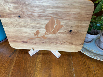 White Oak charcuterie board with subtle Cherry rose and stem inlay, handcrafted by Fitzgerald Custom Woodcraft