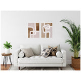Two framed abstract art pieces with rhythmic white and brown curved lines on a textured beige background, hung above a white sofa with patterned throw pillows in a bright living room.