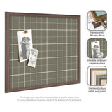 Sage green plaid fabric pinboard with white grid lines and a dark wood frame, displaying two black-and-white photos pinned with wooden pegs.
