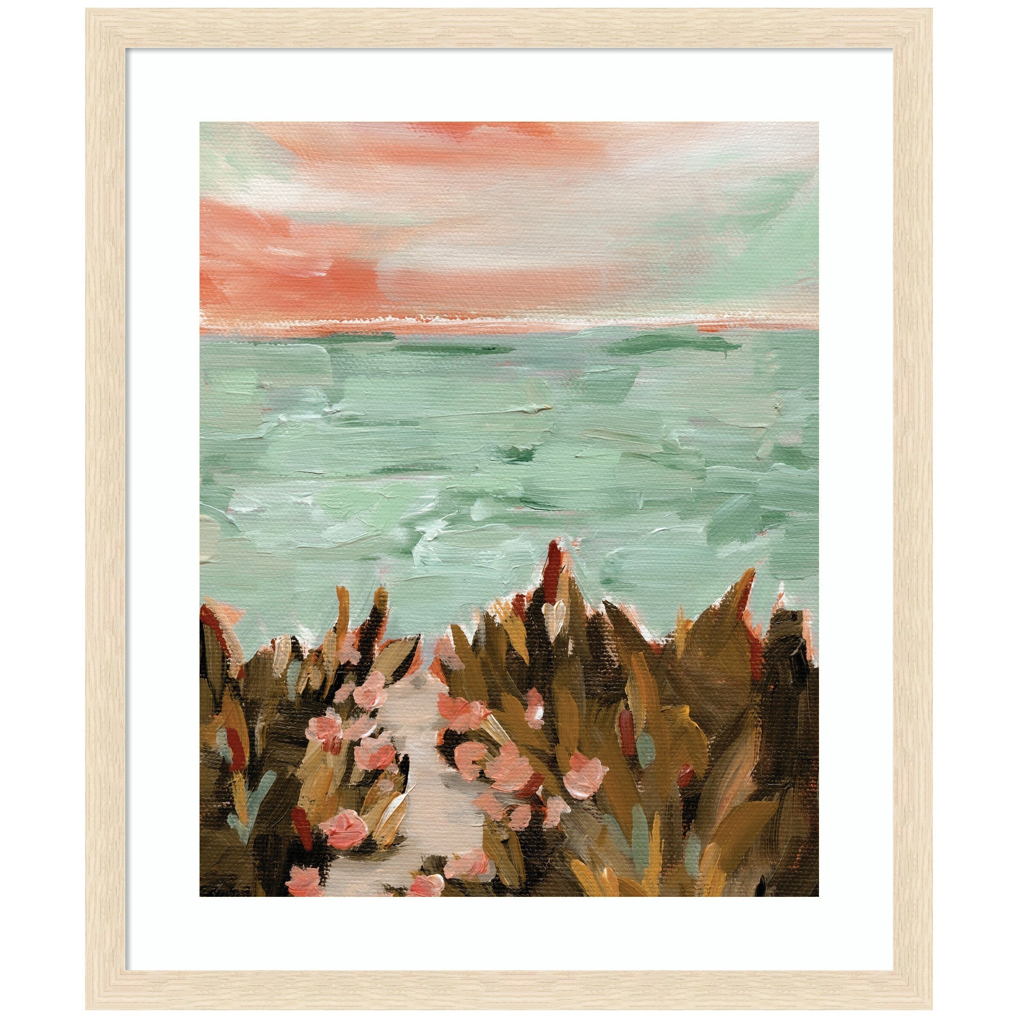 Framed art print showing a coastal beach landscape at sunset with sandy path, green vegetation, and pastel sky