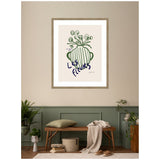Framed minimalistic wall art print of a green striped vase with round flowers and French text 'Les Fleurs' on a beige background, hanging above a wooden bench with cushions and plants.