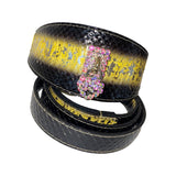 Black snake-patterned collar with a wide yellow-gold metallic stripe and a pink Swarovski crystal heart-shaped latch, displayed coiled on white background.