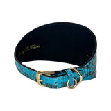 Four-inch wide dog collar with turquoise and black textured pattern and gold-tone buckle and D-ring, shown curved on white background.