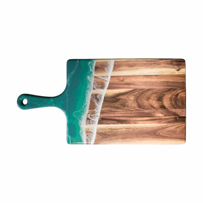 Wooden resin charcuterie board with a green handle and ocean wave design on a white background