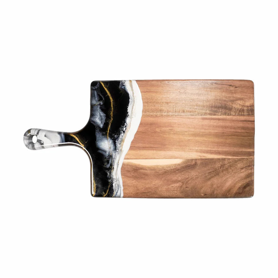 Wooden resin charcuterie board with a black and gold handle on a white background