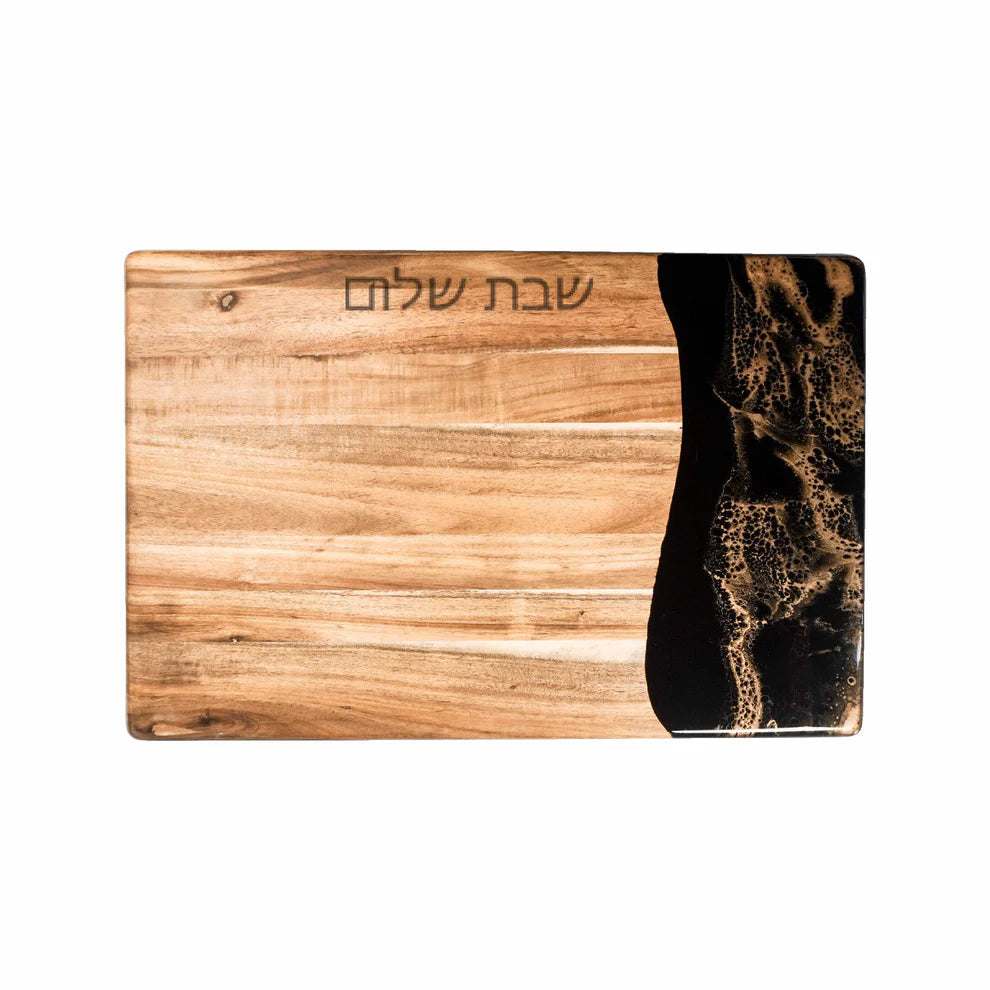 Wooden resin charcuterie board with black and gold design on a white background