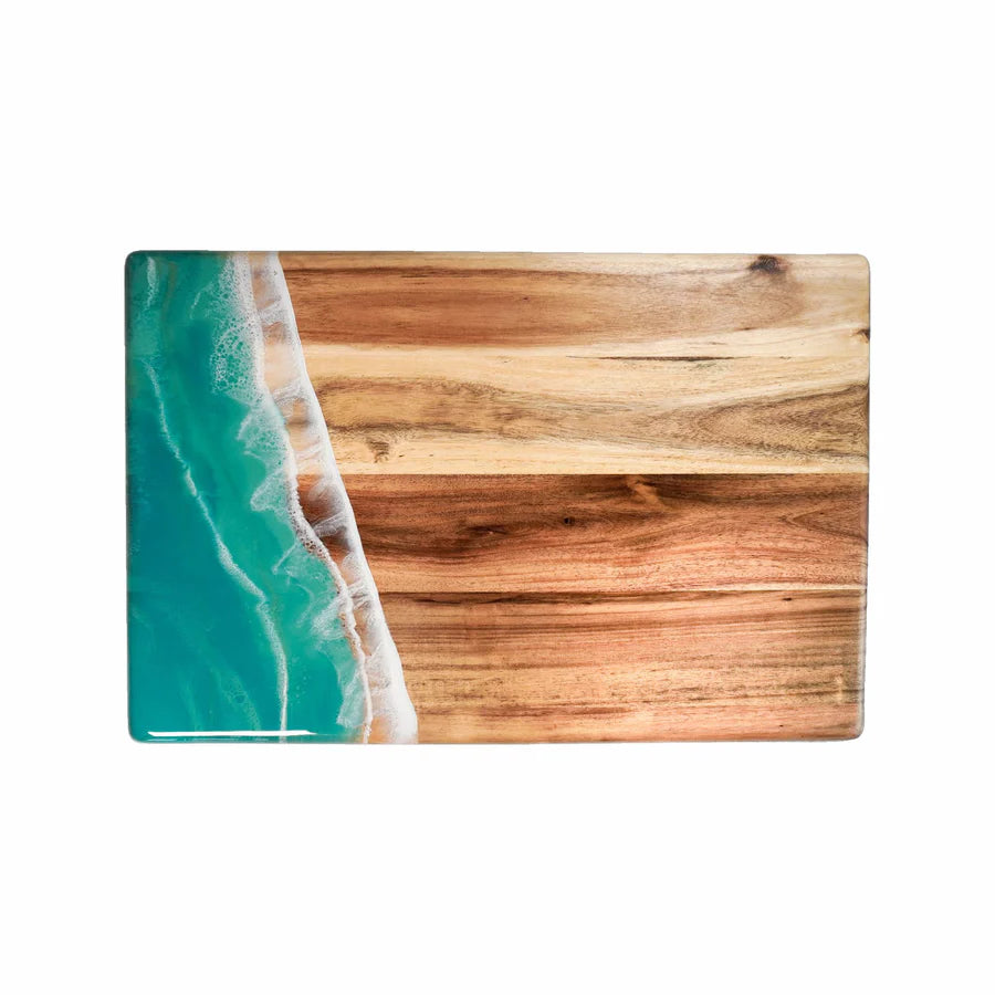 Rectangular acacia resin serving bread board with wooden texture on one side and ocean wave design on the other, on a white background.