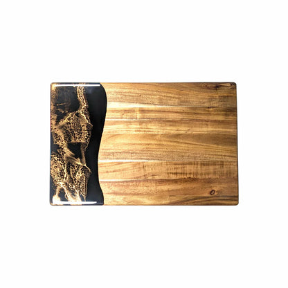 Wooden acacia resin serving bread board with black and gold design on a white background