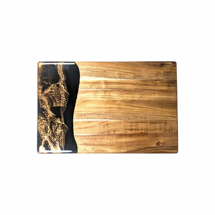 Wooden acacia resin serving bread board with black and gold design on a white background