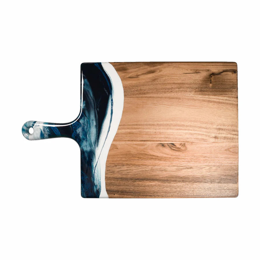 Wooden charcuterie serving tray with a handle featuring a blue and white abstract design on a white background